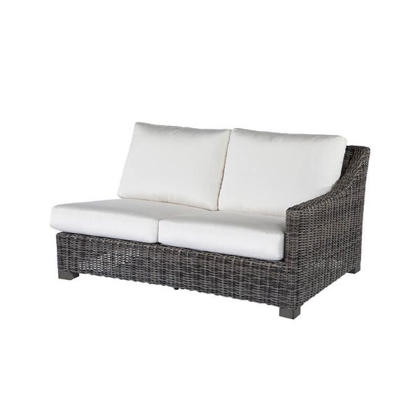Woven wicker left arm loveseat with white cushions in smoke finish.