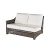 Woven wicker right arm loveseat with white cushions in hickory finish.