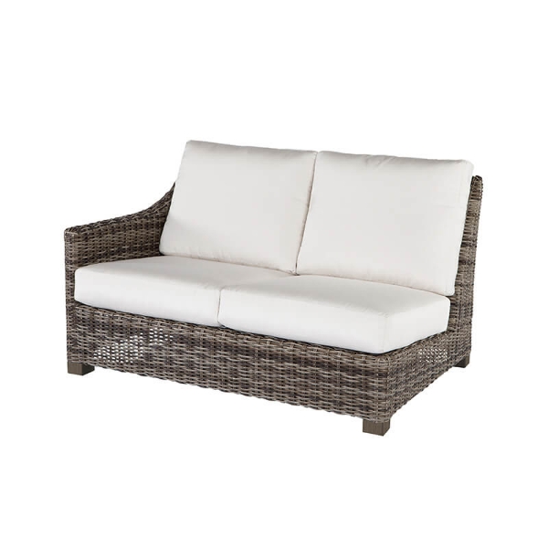 Woven wicker right arm loveseat with white cushions in hickory finish.
