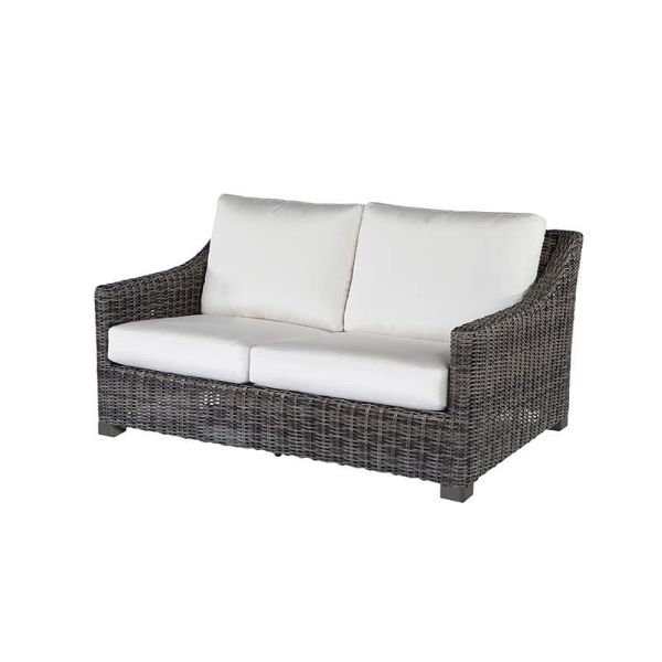 Dark wicker loveseat with white cushions in smoke finish.