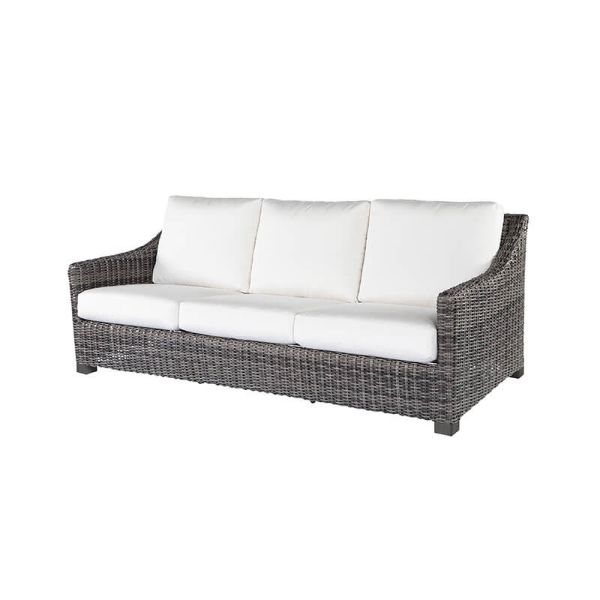 Woven wicker three-seat sofa with white cushions in smoke finish.