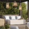 Outdoor wicker sofa with gray cushions and white pillows on a covered patio.