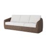 Boulevard wicker sofa with white cushions in hazel finish.
