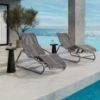 Resort pool deck with Cabana woven comfort chaise lounges in fog gray and graphite frames overlooking the ocean