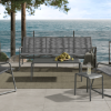 Outdoor resort patio with Cabana woven sofa in Fog and Graphite finish overlooking the ocean
