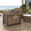 Outdoor patio setup with Corte woven padded club chairs in Cocoa and Hazel finish around a fire table