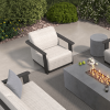 Outdoor firepit lounge with Corte woven padded club chair in Onyx and Pearl finish for commercial patio furniture