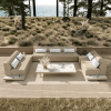 Grande wicker armless loveseat sectional in Barley Flax arranged on a deck with ocean backdrop.