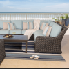 Laurent wicker left sectional loveseat as part of a coastal patio sectional set with blue cushions and striped pillows.