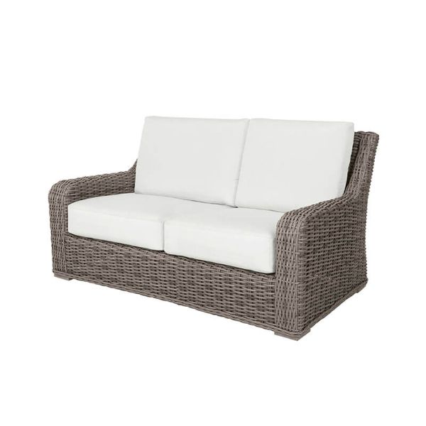 Laurent wicker cushion loveseat in Driftwood finish with white cushions, designed for outdoor patios and resort seating.