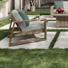 Contemporary Novara Patio Club Chair with Light Wood Frame and Teal Cushion Accents in a Garden Setting