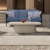 Orleans Woven Cushion Patio Sofa in Coal Finish with Blue Cushions on Outdoor Deck