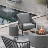 Outdoor lounge with Palazzo deep seating patio club chairs around a round fire pit by the pool.