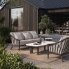 Outdoor patio scene featuring Palazzo deep seating sofa in Cocoa finish with matching club chairs and modern coffee table.