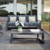 Palermo rectangular patio coffee table with slatted top in outdoor setting with sofa and white orchid centerpiece