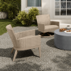 Siena wicker patio club chairs in Barley Flax finish placed in a garden setting with round table