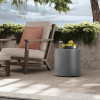 18″ round Bellino side table in concrete finish styled with lounge seating on a coastal patio.