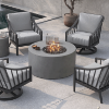 Modern outdoor seating area with a round gray Bellino fire pit table surrounded by cushioned chairs