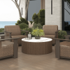 Hampton round patio chat table with marble-inspired top and wicker armchairs by ocean view