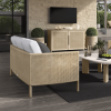 Outdoor living space featuring Orleans woven patio sideboard in barley flax finish with sofa and mounted TV.