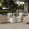Tahoe 54" x 35" Shell Patio Fire Pit Table with flames in outdoor lounge by pool
