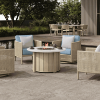 Trevi 50 inch round flax finish fire pit patio table with wicker chairs and dining set in outdoor resort setting