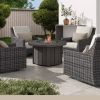 Trevi Pompano Fire Pit Patio Table in Outdoor Resort Setting with Wicker Lounge Chairs and Cushions