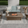 70" × 32" XL Trevi Fire Pit Patio Table with Flax Finish shown with woven seating for luxury outdoor spaces