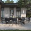 Orleans Woven Seat Patio Dining Arm Chairs around modern outdoor dining table in elegant resort patio setting