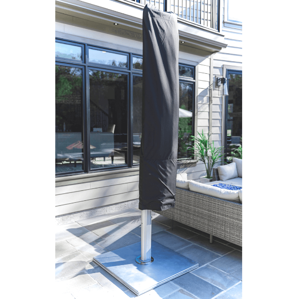 Eclipse 10 foot square aluminum cantilever umbrella with protective cover installed on patio base for off-season commercial outdoor storage