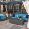 Highland Gray wicker outdoor patio sofa with blue cushions in a coordinated commercial outdoor lounge setting