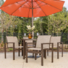 Urban stackable aluminum sling club patio dining chairs arranged around an outdoor table beneath an orange umbrella