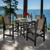Polywood Coastal Sling Dining Chairs with dark frames and neutral sling fabric arranged around a round outdoor dining table overlooking the water