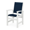 Polywood Coastal Sling Dining Chair with white frame, curved armrests, and navy blue fabric sling seat and back