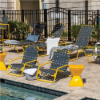 Sundance stackable cross-weave commercial patio sand chairs with yellow aluminum frames and charcoal woven vinyl straps arranged poolside