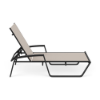 Side view of Skyline sling commercial poolside chaise lounge with MGP arms, Starlight Black frame, Cane Oyster sling fabric, and adjustable back