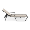 Side view of Skyline padded sling commercial poolside chaise lounge with Starlight Black frame, Cane Oyster padded sling, and adjustable back