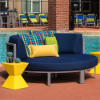 Yellow 14" Diamond fiberglass commercial side table beside cushioned commercial lounge seating on a resort pool deck